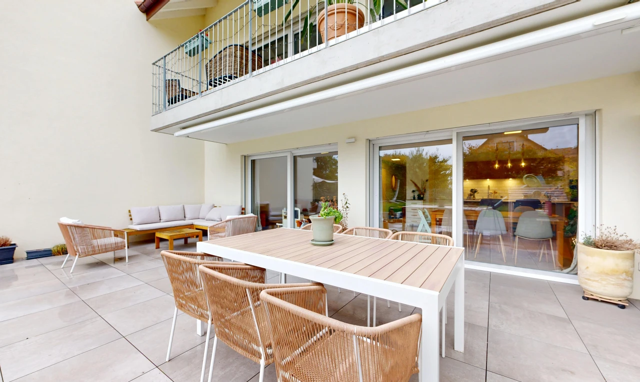 terrace featuring a balcony, a patio area, and an outdoor living / dining area