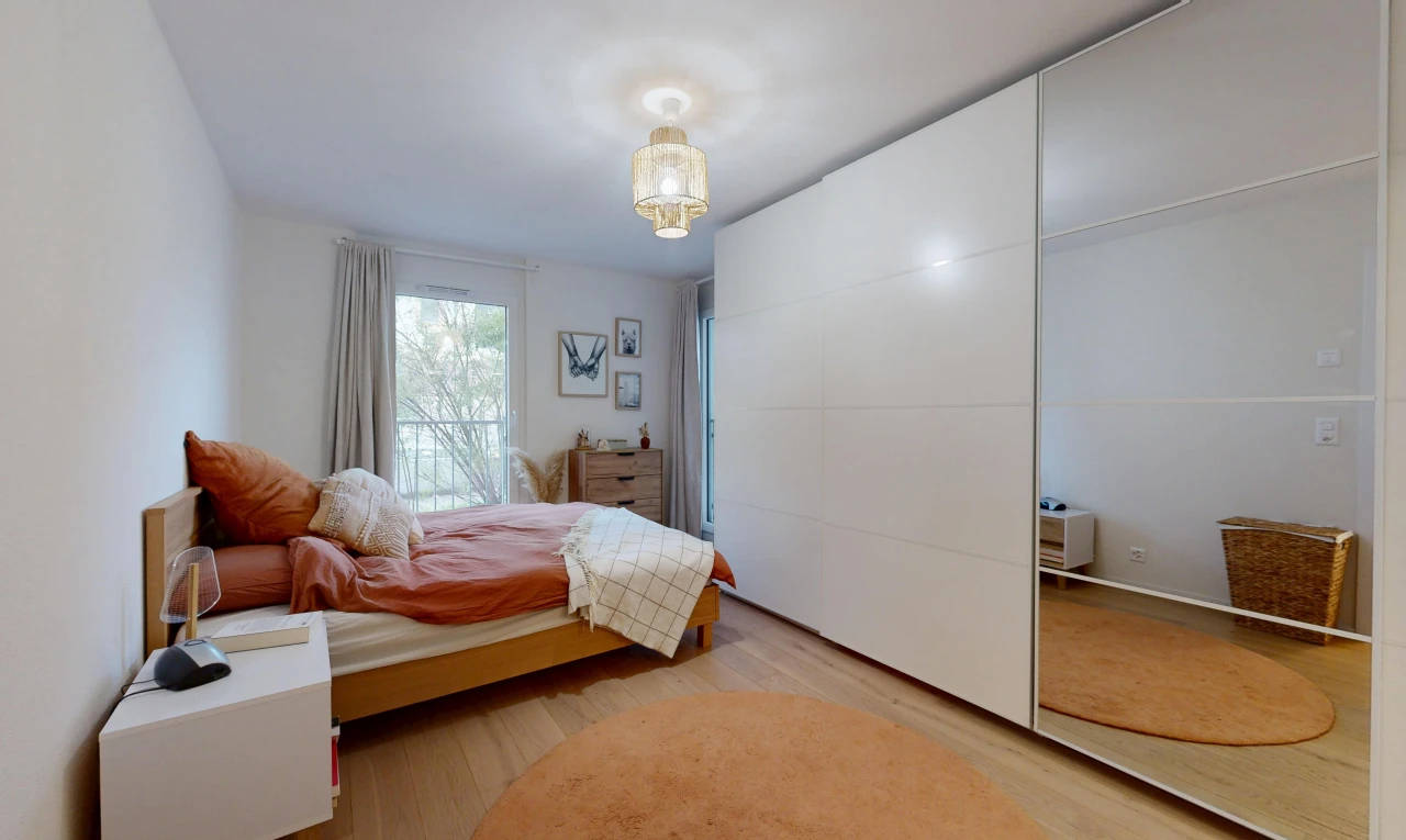 room with light wood-type flooring and a closet