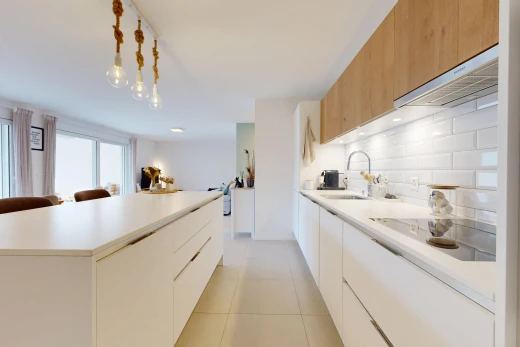 kitchen featuring two tone color scheme, modern cabinets, light countertops, and a kitchen island