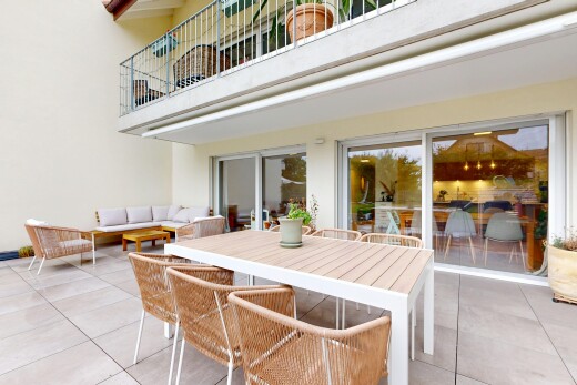 terrace featuring a balcony, a patio area, and an outdoor living / dining area