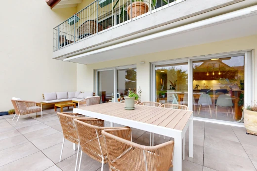 terrace featuring a balcony, a patio area, and an outdoor living / dining area