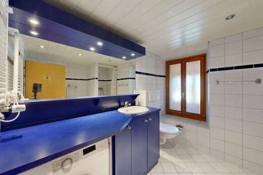 full bath with vanity, light tile patterned floors, tile walls, washer / dryer, and recessed lighting
