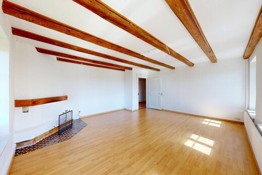 empty room featuring light wood-type flooring and beam ceiling