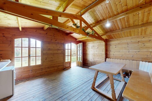 unfurnished dining room with hardwood / wood-style floors, wooden walls, and a wood ceiling with exposed beams