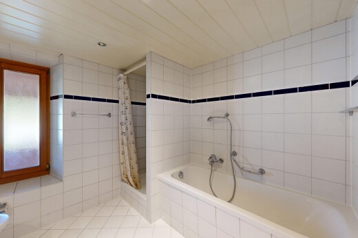 bathroom with tile walls and light tile patterned flooring