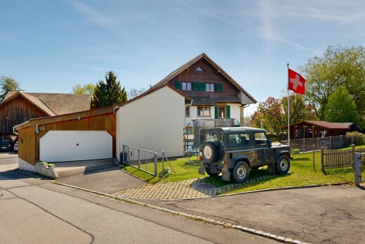 outdoor house with concrete driveway