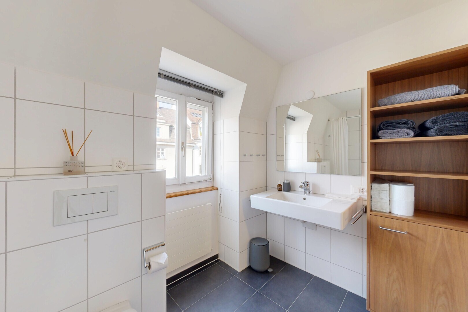 bathroom with dark tile patterned floors and tile walls