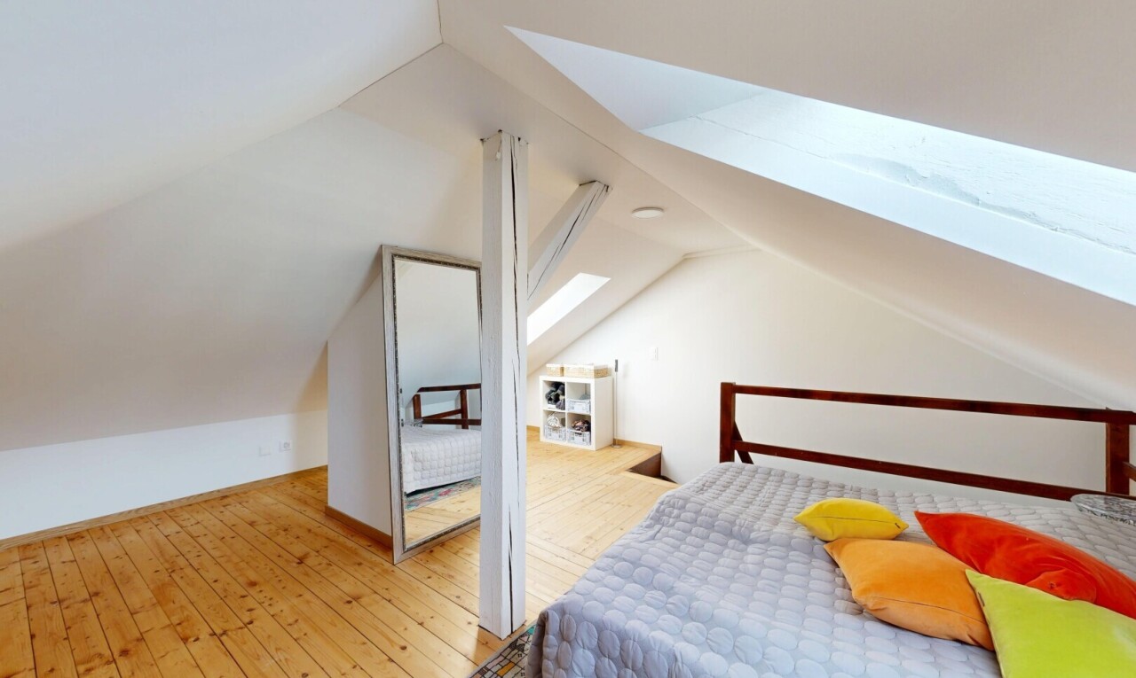 room with a skylight and light wood-type flooring
