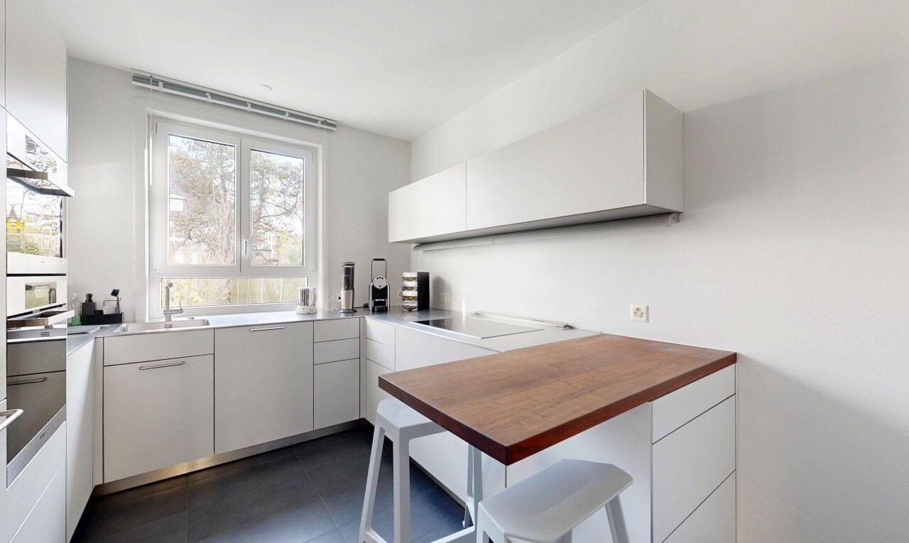 kitchen with white cabinets, modern cabinets, butcher block countertops, and oven