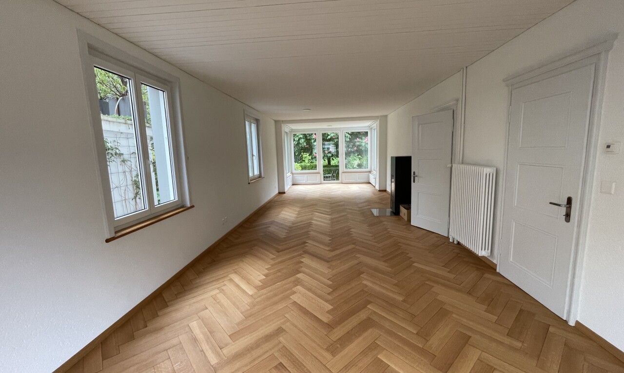 corridor featuring radiator heating unit and parquet floors