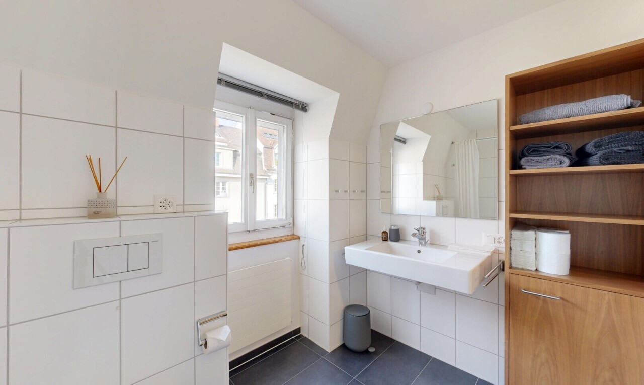 bathroom with dark tile patterned floors and tile walls
