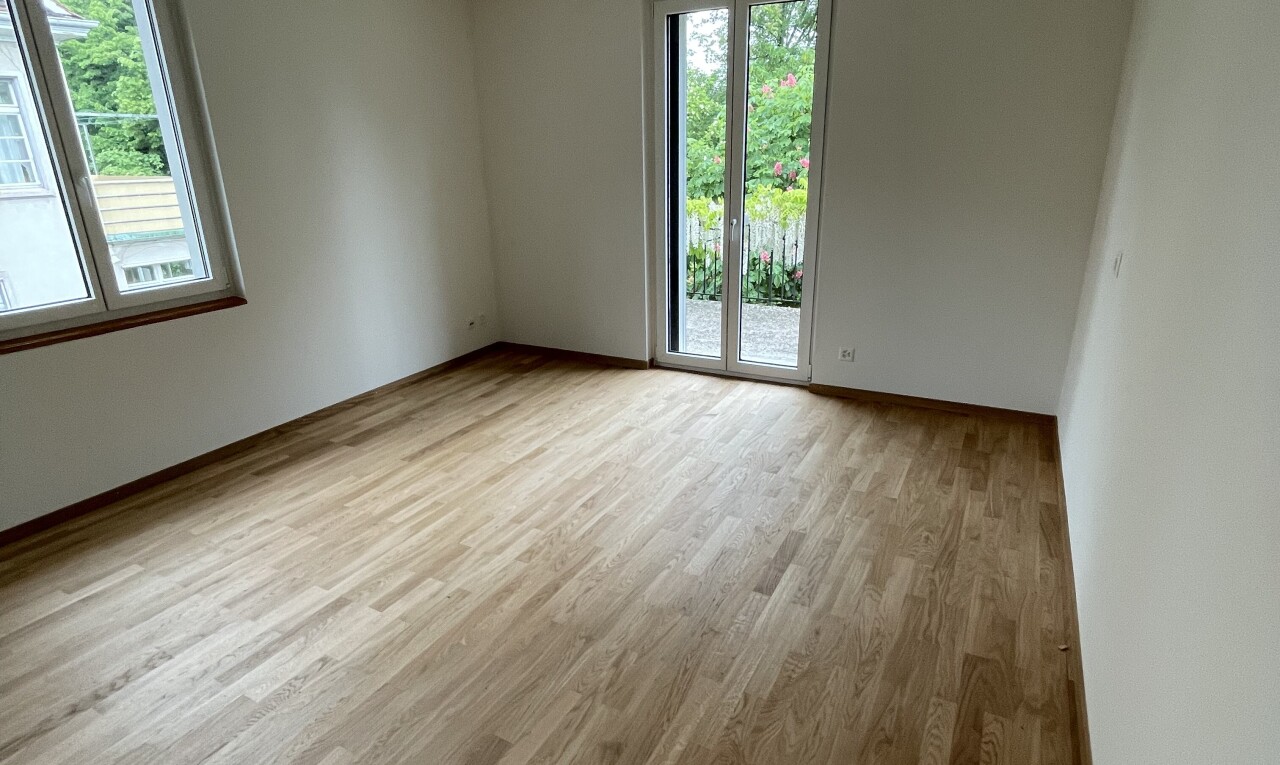 empty room with light wood finished floors and baseboards