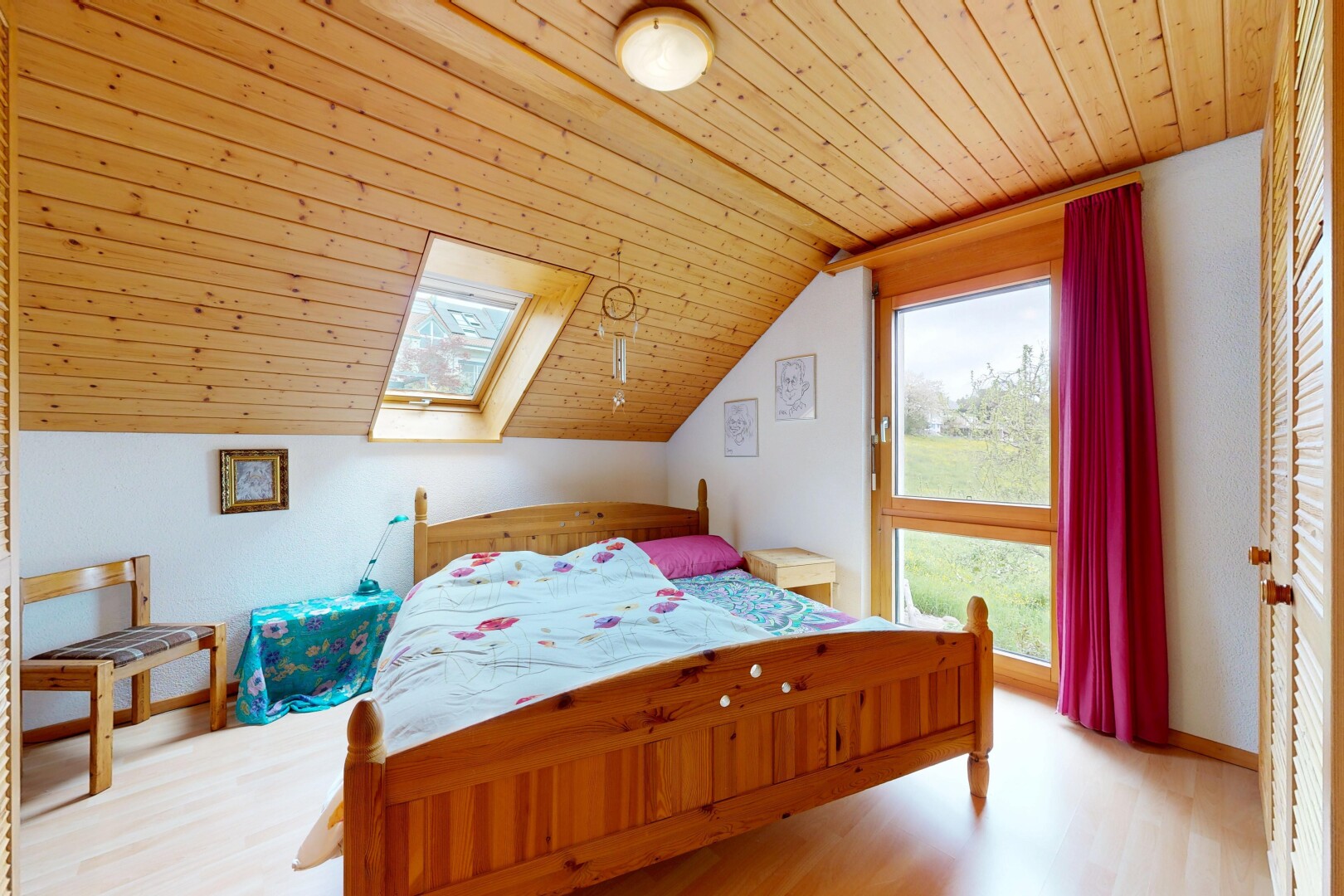 room featuring a vaulted wood ceiling, light wood-style flooring, and a skylight