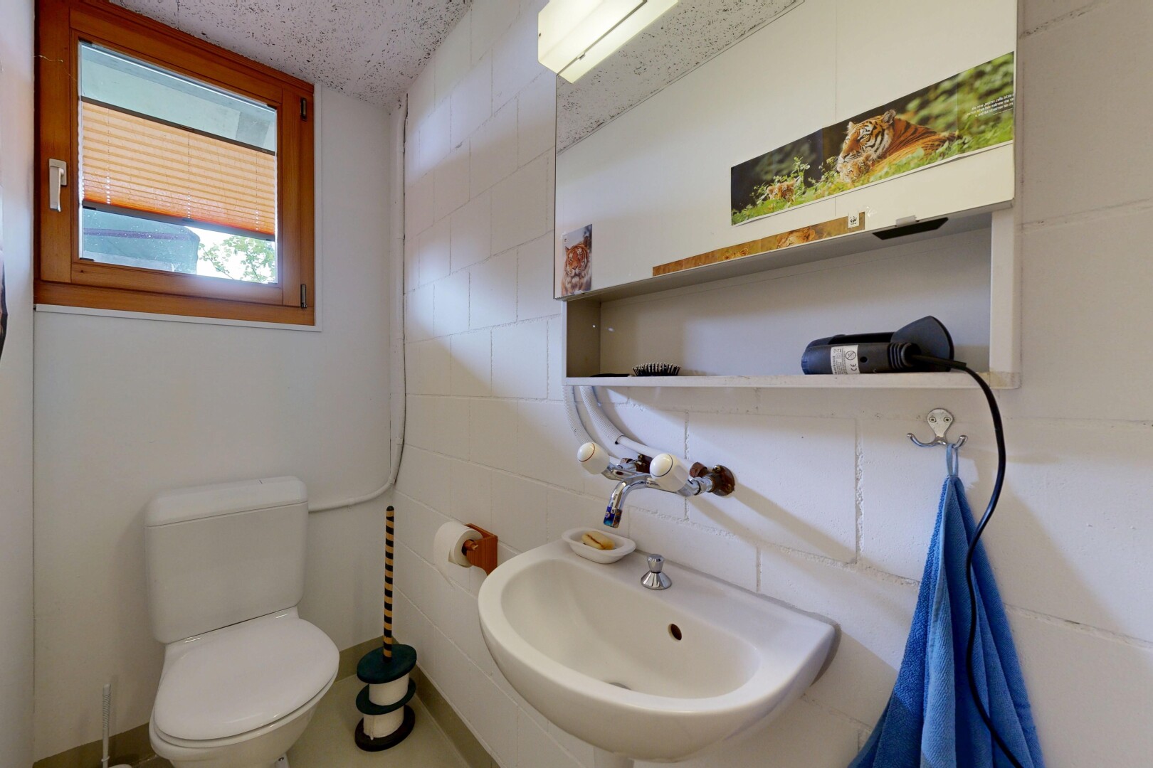 half bathroom with toilet and tile walls