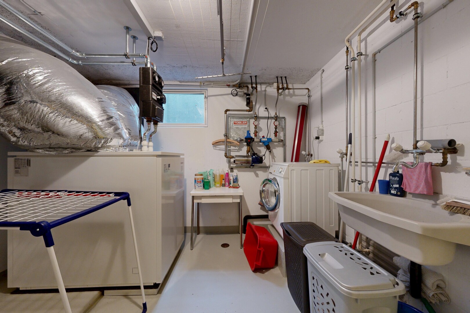 interior space with finished concrete floors and washing machine and clothes dryer