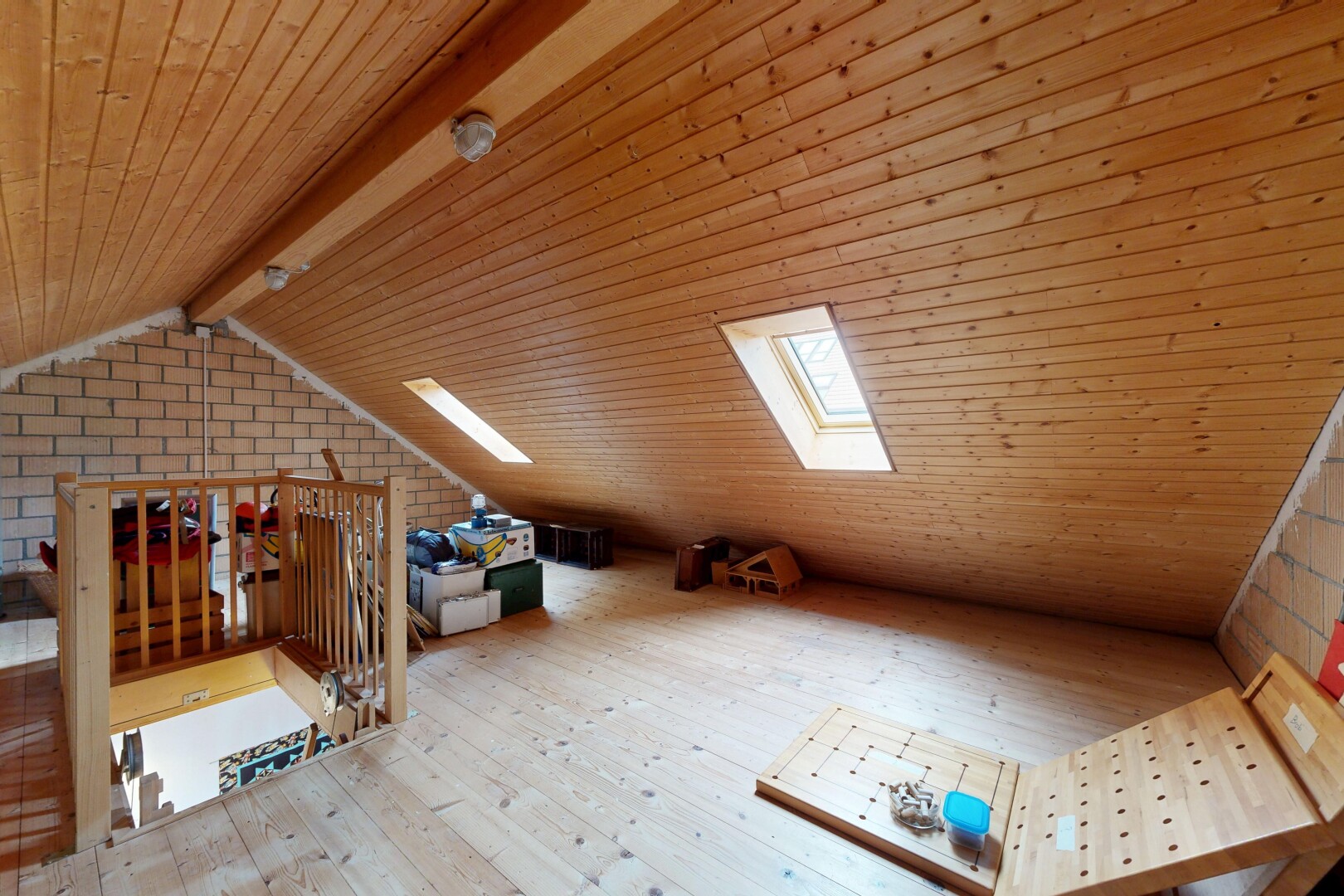 office featuring a wooden ceiling with exposed beams, light wood-style flooring, and brick wall