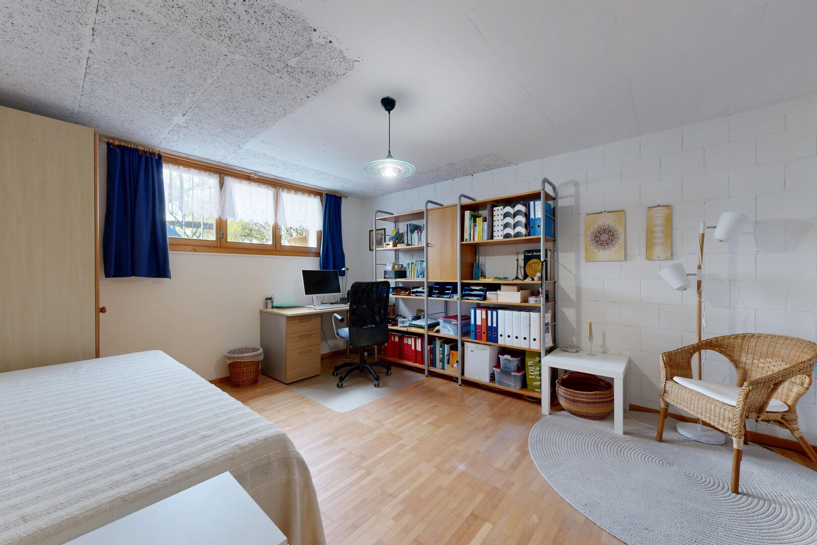 room / bedroom featuring light wood finished floors and an office area