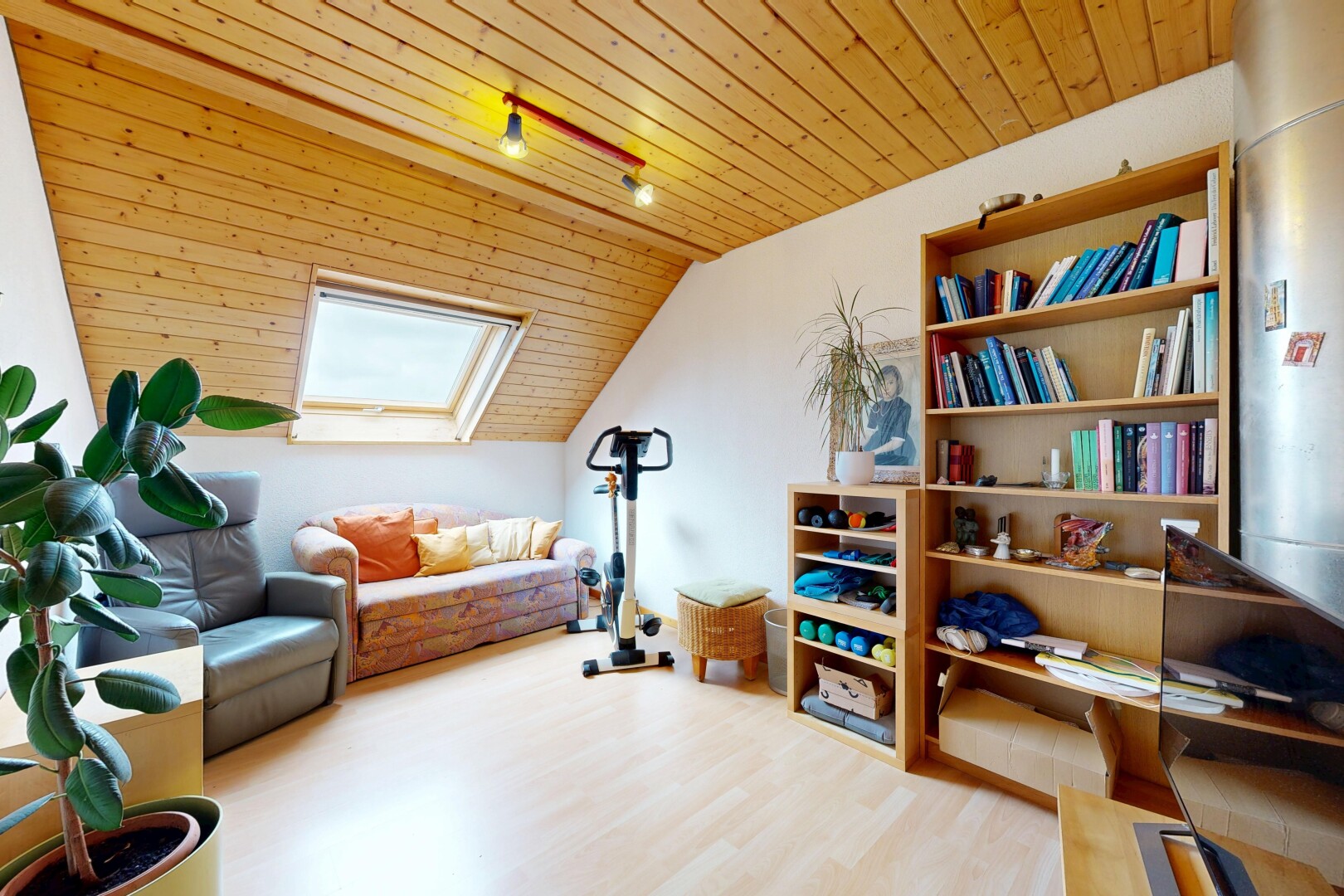 living room featuring a skylight, a vaulted wood ceiling, and light wood finished floors