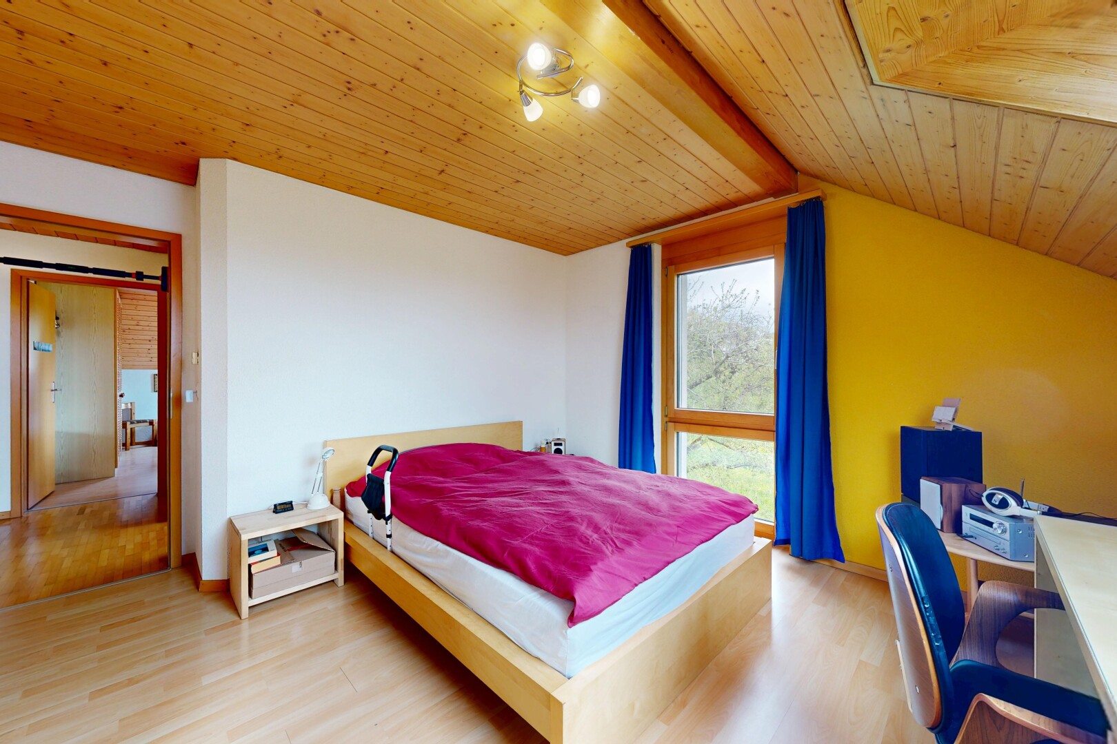 room with light wood-style floors, wooden ceiling, and a desk