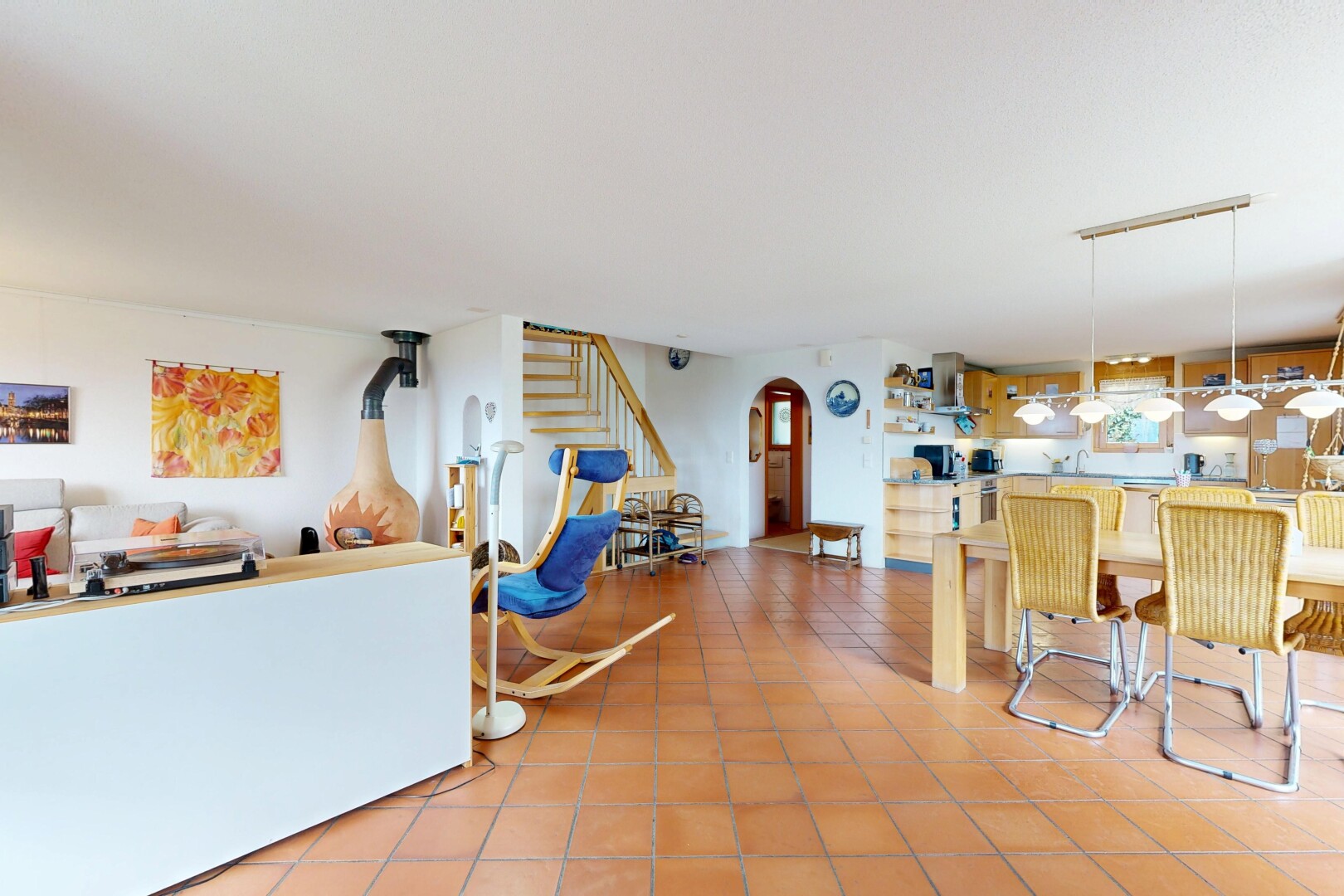 dining space with arched walkways and light tile patterned floors