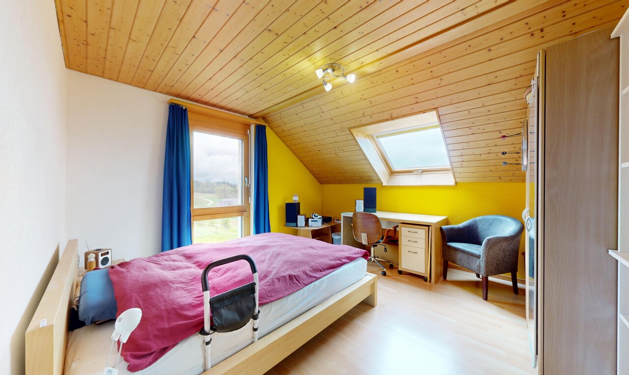 room featuring a vaulted wood ceiling, light wood-style flooring, a skylight, and a desk