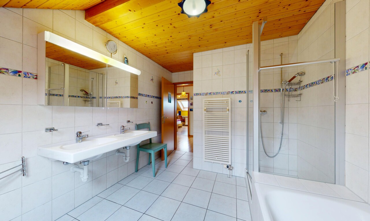 full bath featuring a stall shower, tile walls, a towel warmer, a tub, and radiator
