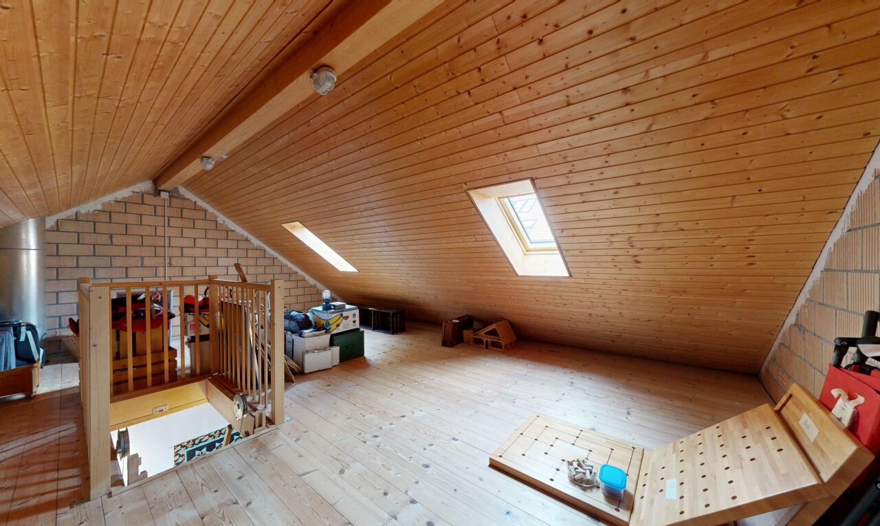 office featuring a wooden ceiling with exposed beams, light wood-style flooring, and brick wall