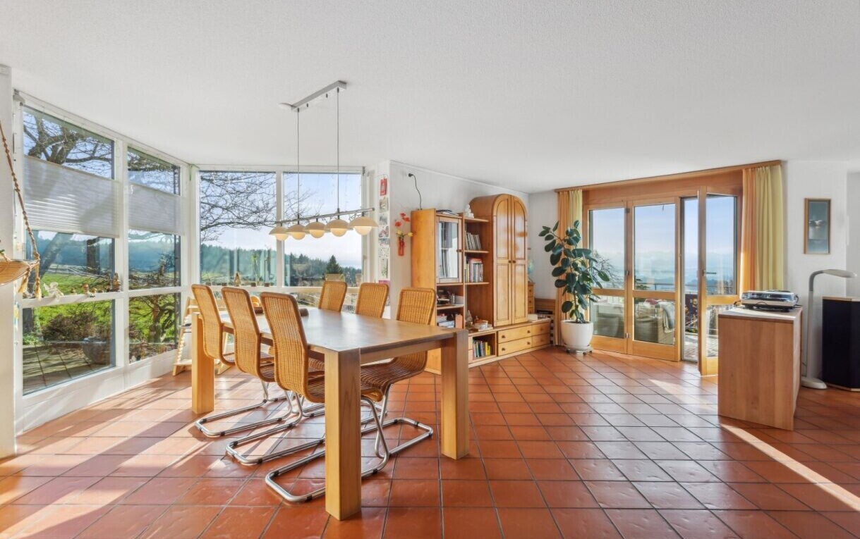 tiled dining room with expansive windows