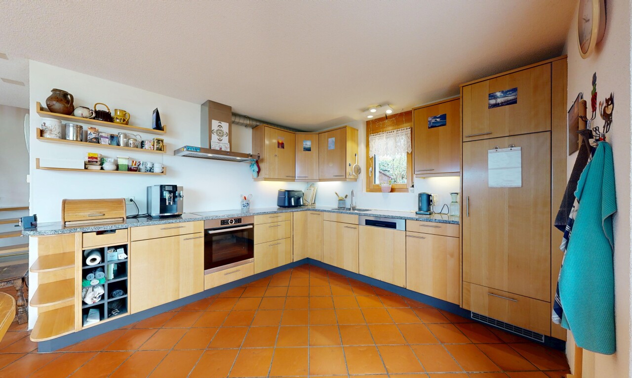 kitchen featuring open shelves, light wood finish cabinetry, stainless steel appliances, light stone counters, and light tile patterned floors
