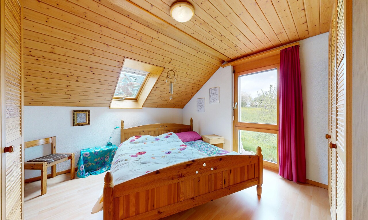 room featuring a vaulted wood ceiling, light wood-style flooring, and a skylight