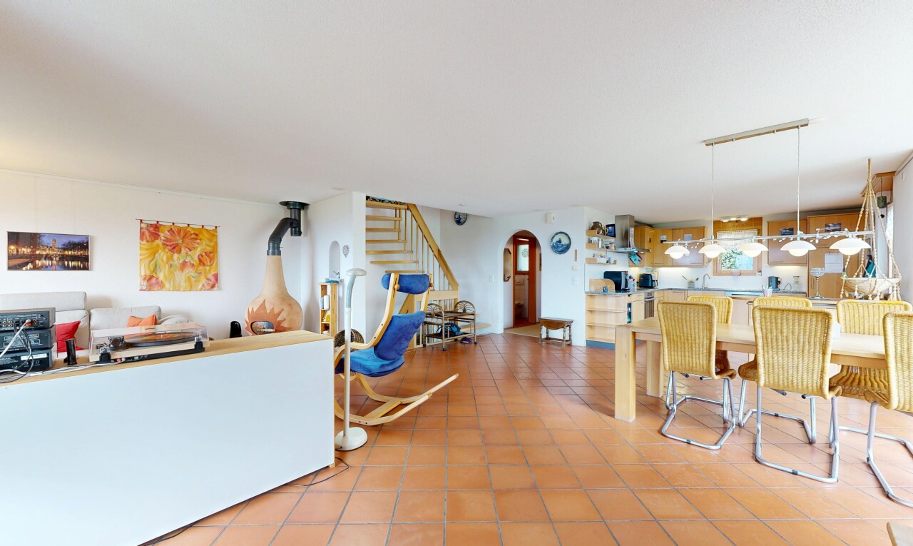 dining space with arched walkways and light tile patterned floors
