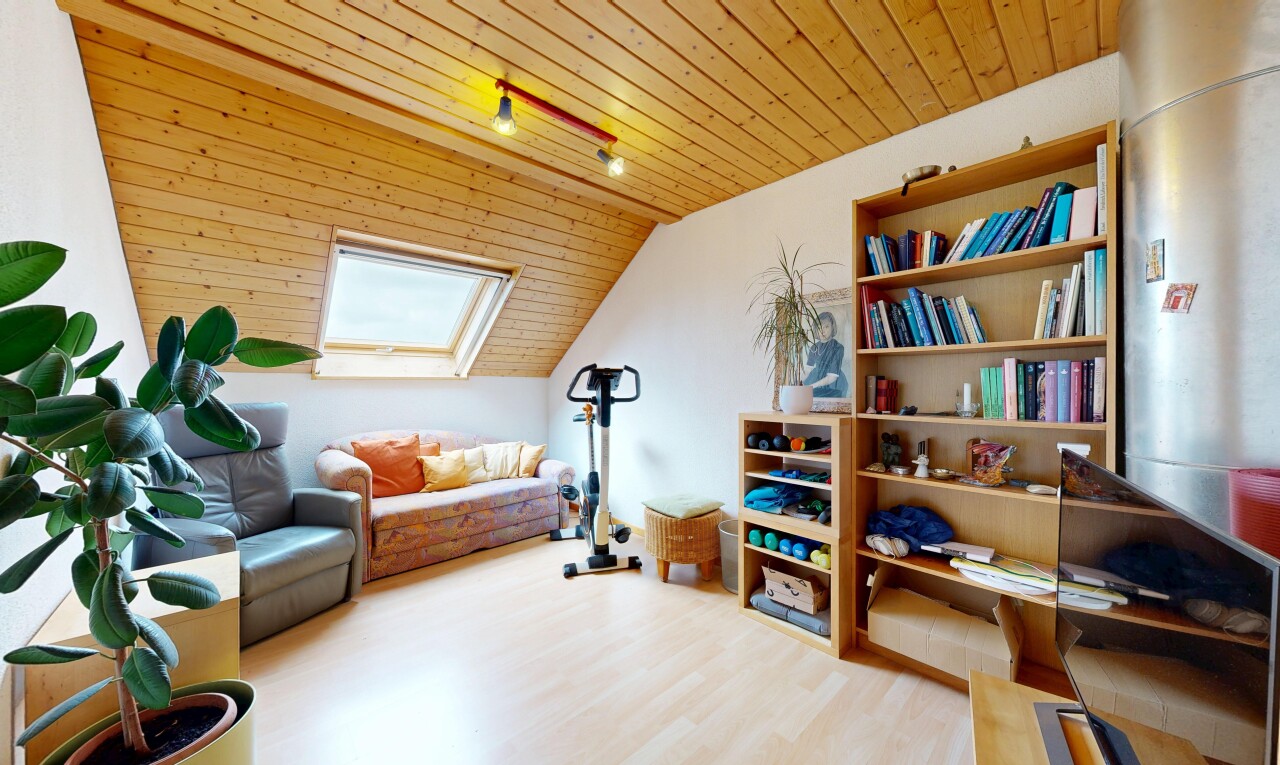 living room featuring a skylight, a vaulted wood ceiling, and light wood finished floors