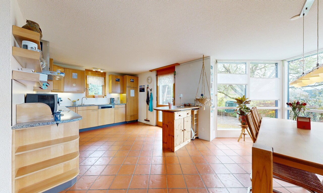 kitchen with open shelves, light wood finish cabinetry, light tile patterned floors, and hanging light fixtures
