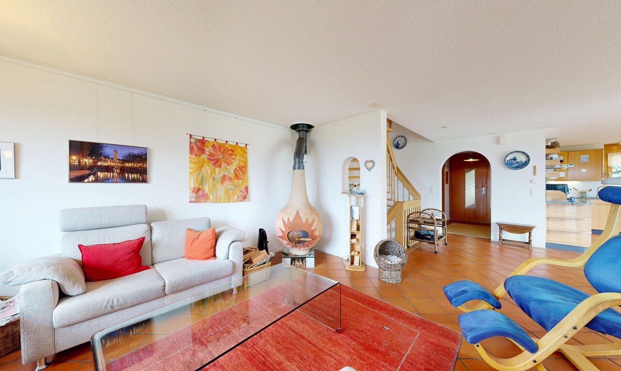 living room with arched walkways and tile patterned flooring