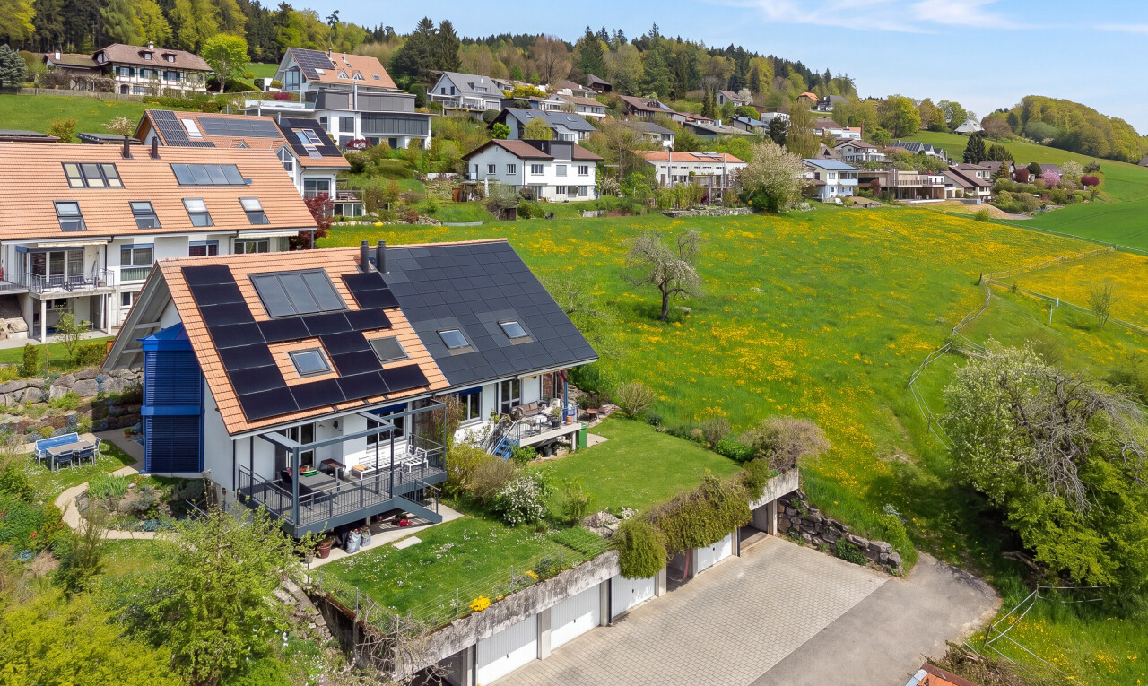 outdoor house featuring solar panels and a wooden deck