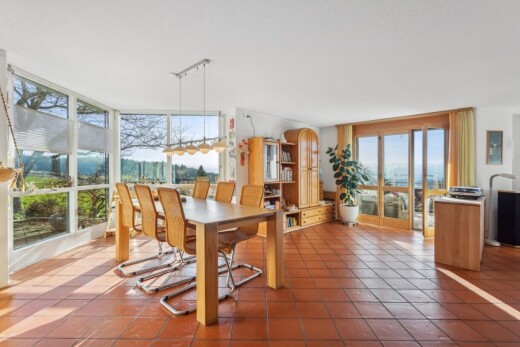 tiled dining room with expansive windows