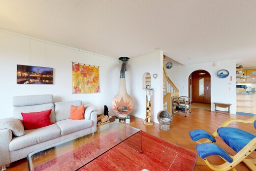 living room with arched walkways and tile patterned flooring