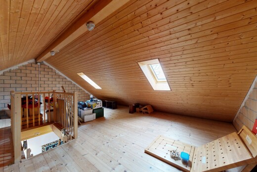 office featuring a wooden ceiling with exposed beams, light wood-style flooring, and brick wall