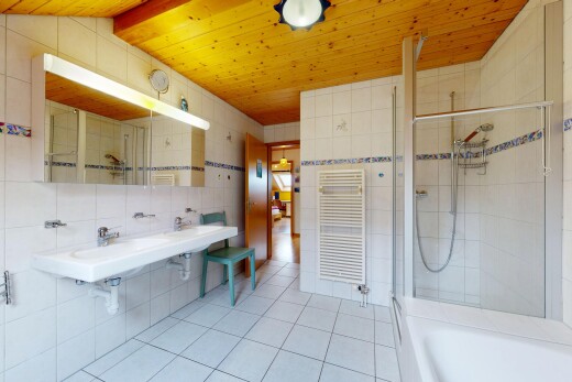 full bath featuring a stall shower, tile walls, a towel warmer, a tub, and radiator