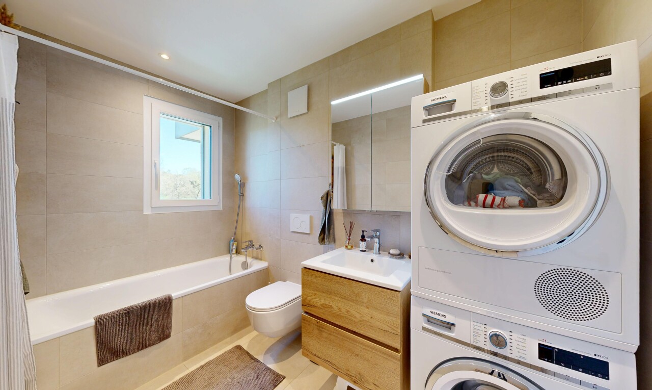 salle de bains avec tile wall, mur en carrelage, miroir, lavabo (ou coiffeuse selon le contexte), et salle de bain complète