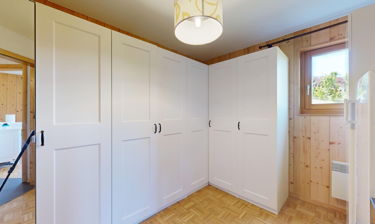 chambre avec parquet floor, sol en finition bois, wood finish floor, inside property, et lumière naturelle