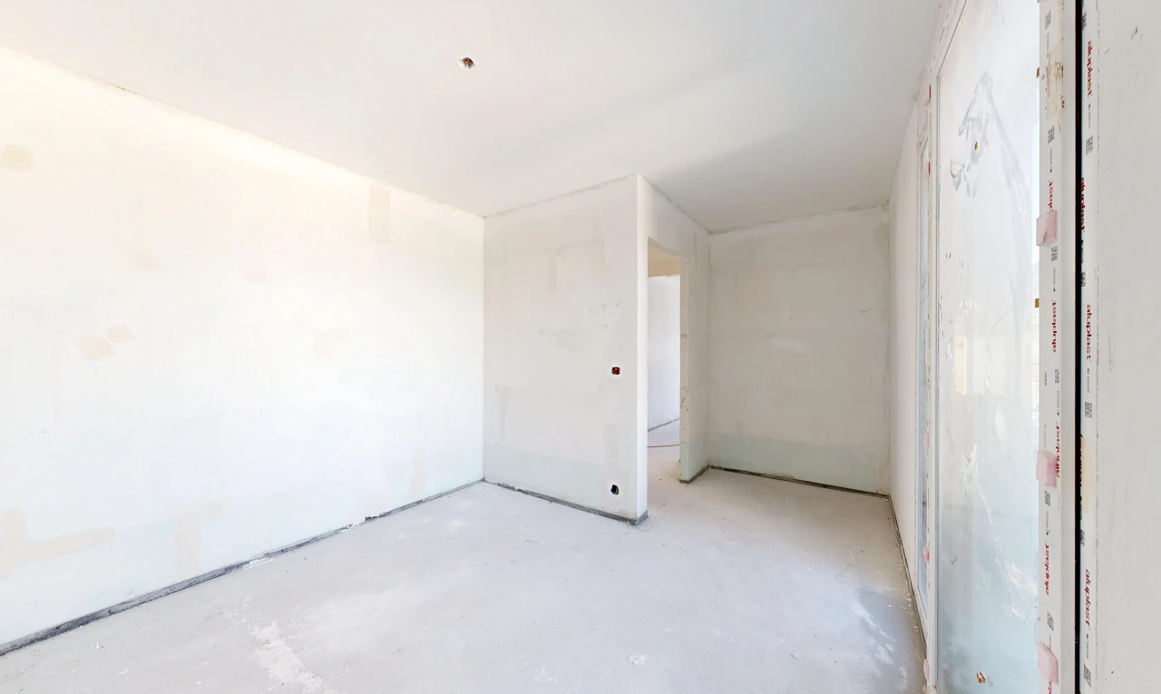 pièce vide avec concrete floor, sol en béton, inside property, drywall, et cloison sèche