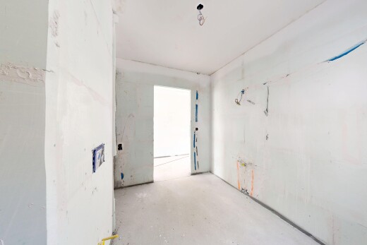 pièce vide avec inside property, concrete floor, sol en béton, drywall, et cloison sèche