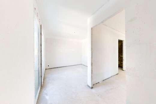 pièce vide avec inside property, concrete floor, sol en béton, drywall, et cloison sèche