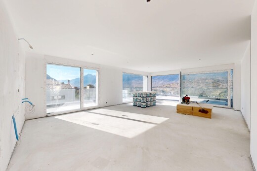 salon avec inside property, concrete floor, sol en béton, vue sur la montagne, et mountain view