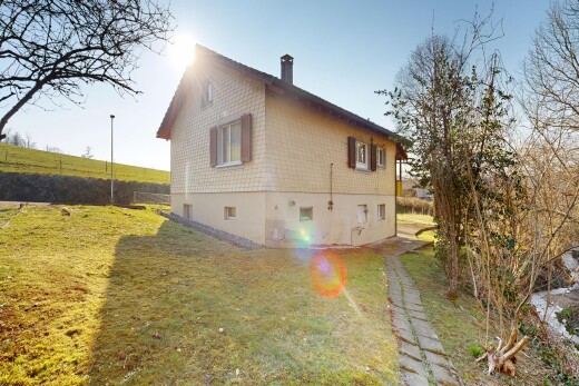 view of home with a yard and a chimney