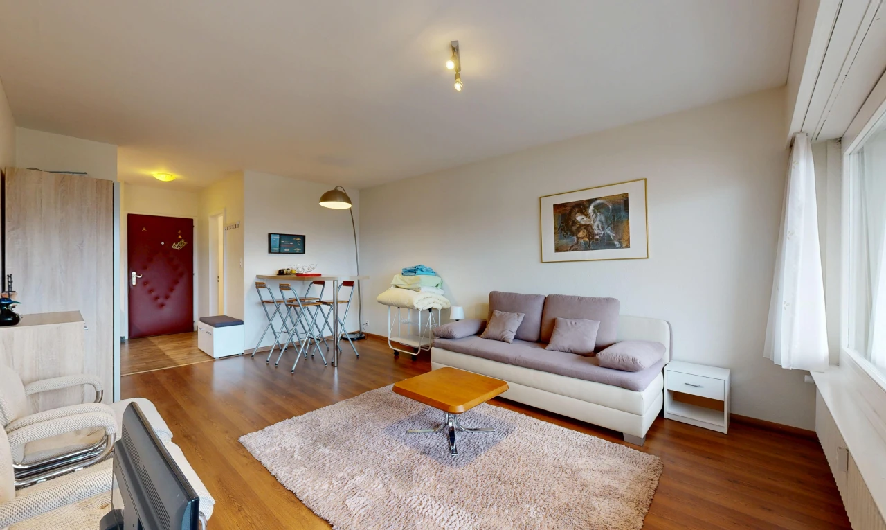 salon avec cloison sèche, drywall, inside property, sol en finition bois, et wood finish floor