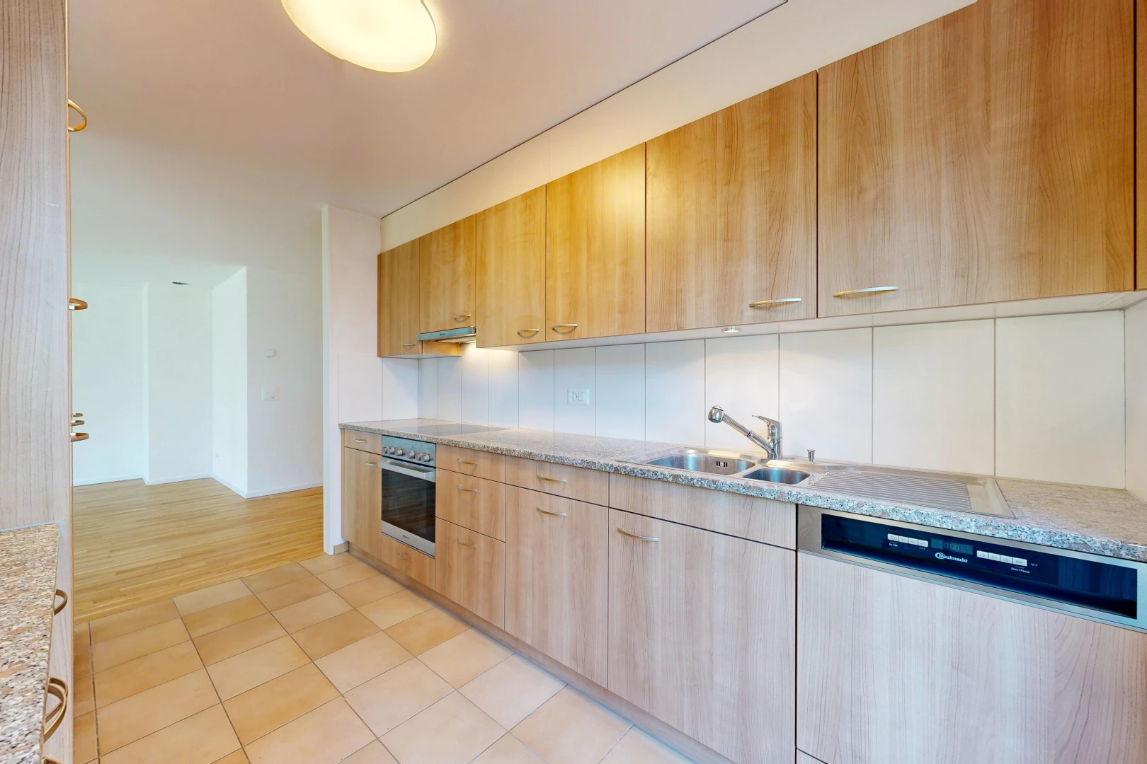 küche mit geschirrspülmaschine, light countertops, light floor, waschbecken, und light brown cabinets