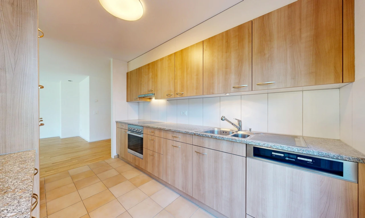 küche mit geschirrspülmaschine, light countertops, light floor, waschbecken, und light brown cabinets