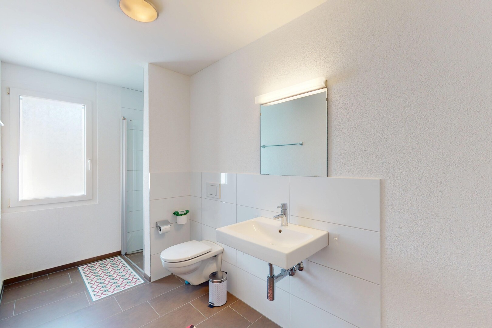 bathroom with a sink, tile patterned floors, a shower stall, and toilet
